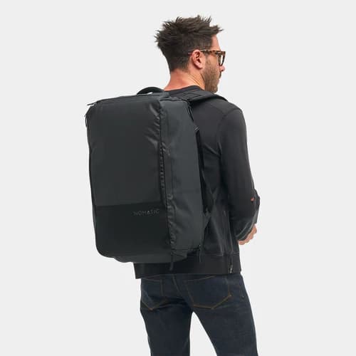 Nomatic Travel Bag 40L carried as a briefcase