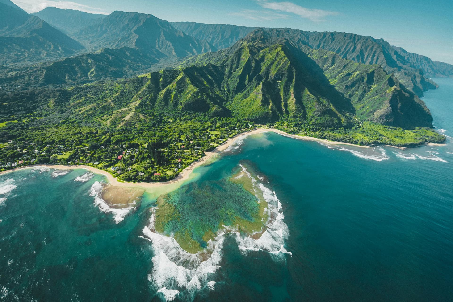 A beautiful beach scene in Hawaii with turquoise water and volcanic rock.